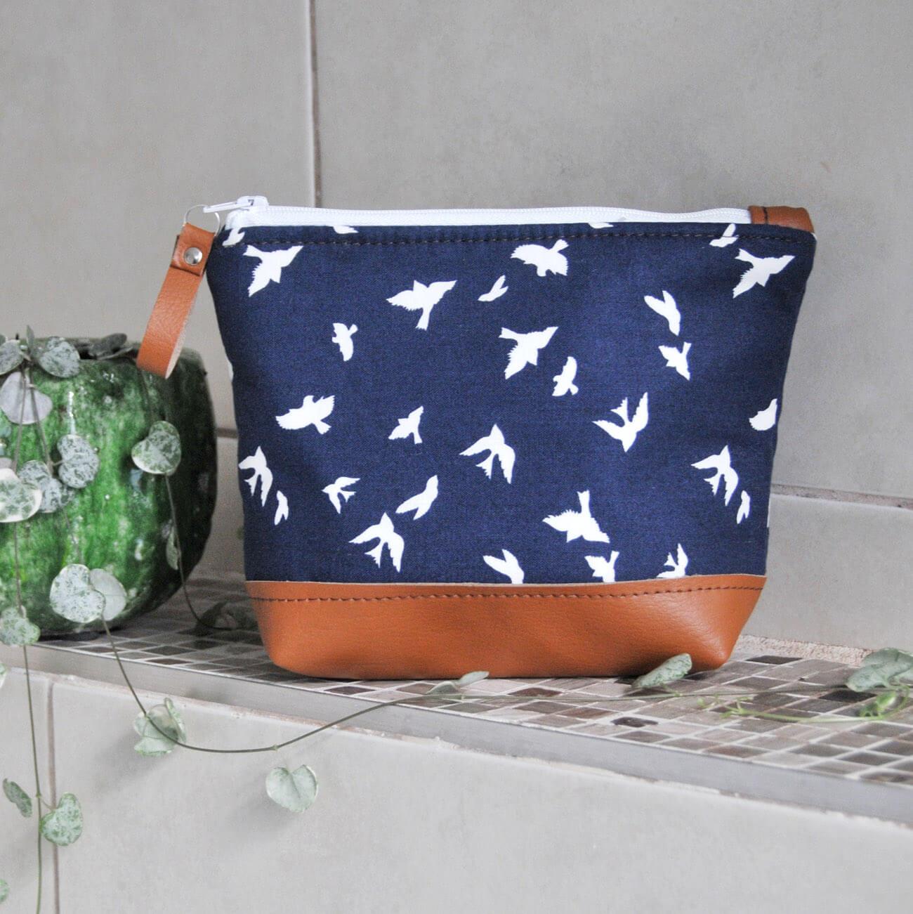 Small recycled leather make up bag in navy bird