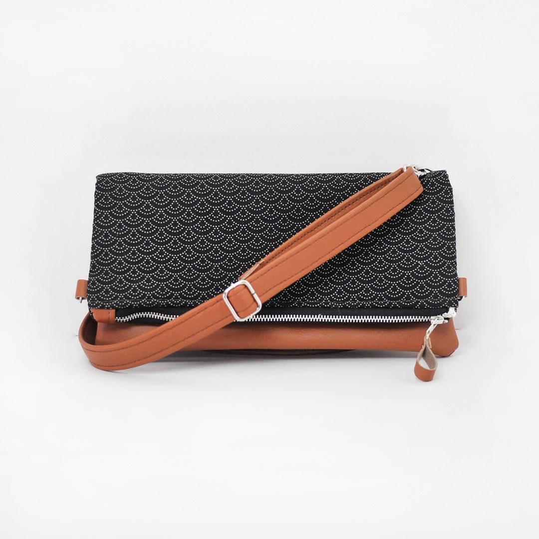 Recycled leather fold over clutch bag in navy bird