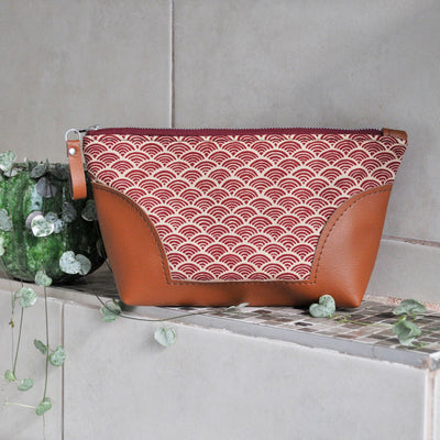 Recycled leather toiletry bag in red Japanese wave fabric in bathroom setting