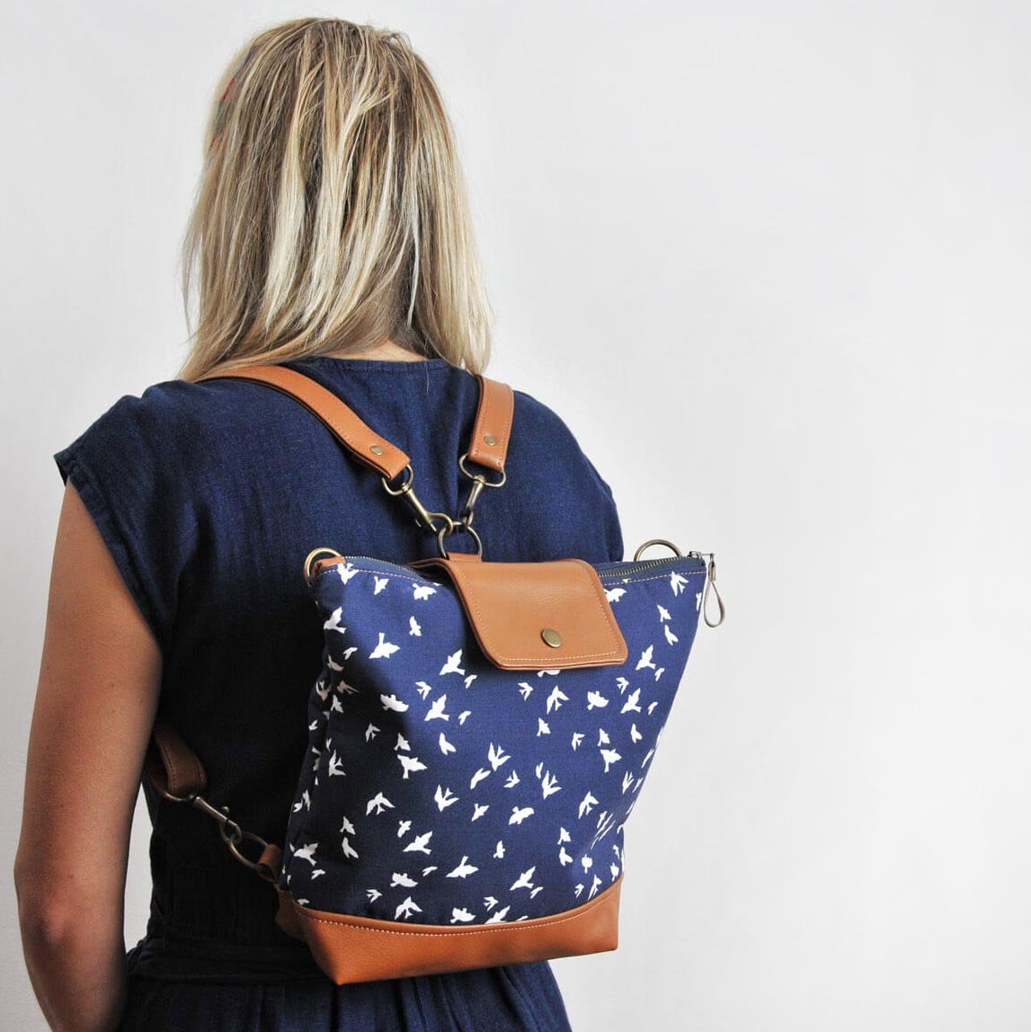 Recycled leather convertible backpack in navy bird fabric by Lauren Holloway, sustainable bags and accessories handmade in the UK