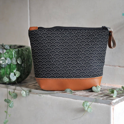 Recycled leather make up bag in black Japanese wave fabric in bathroom setting
