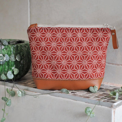 Recycled leather make up bag in red asanoha cotton fabric in bathroom setting