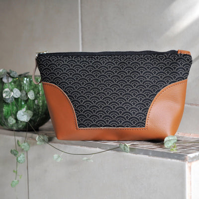 Recycled leather toiletry bag in black Japanese wave fabric in bathroom setting