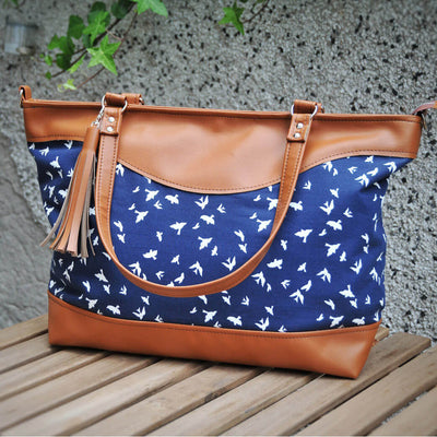 Recycled leather weekender bag in navy bird fabric